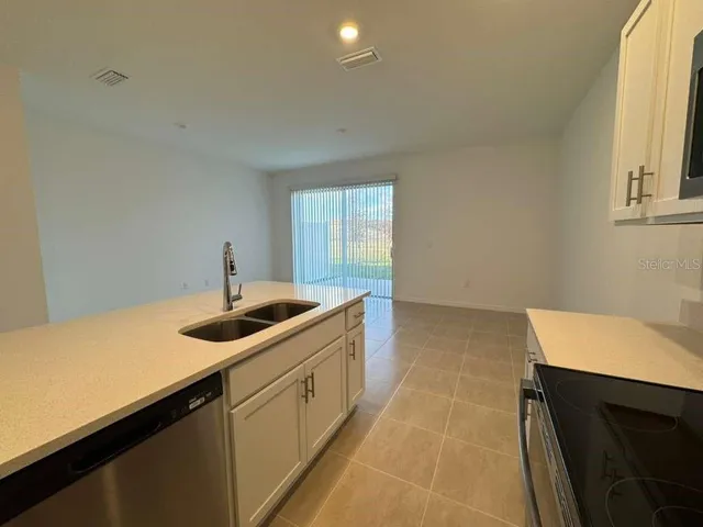 a kitchen with a sink and a stove