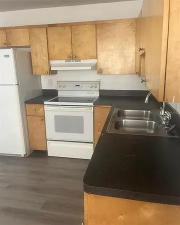 a kitchen with a stove and a refrigerator