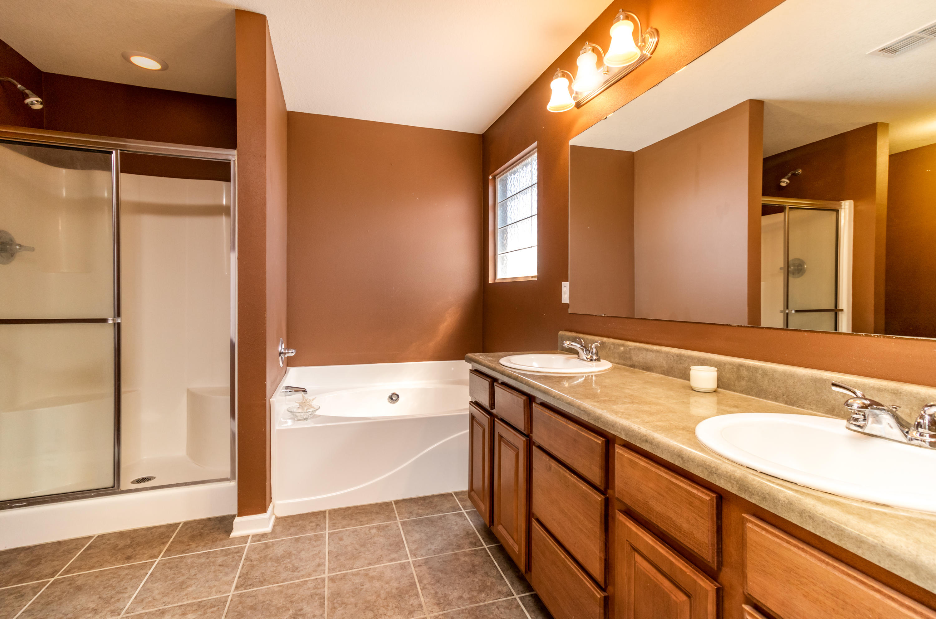 2609 Corner Creek Road Crestview, FL 32536 - Photo 16 of 22 a bathroom with a granite countertop sink mirror and a bathtub