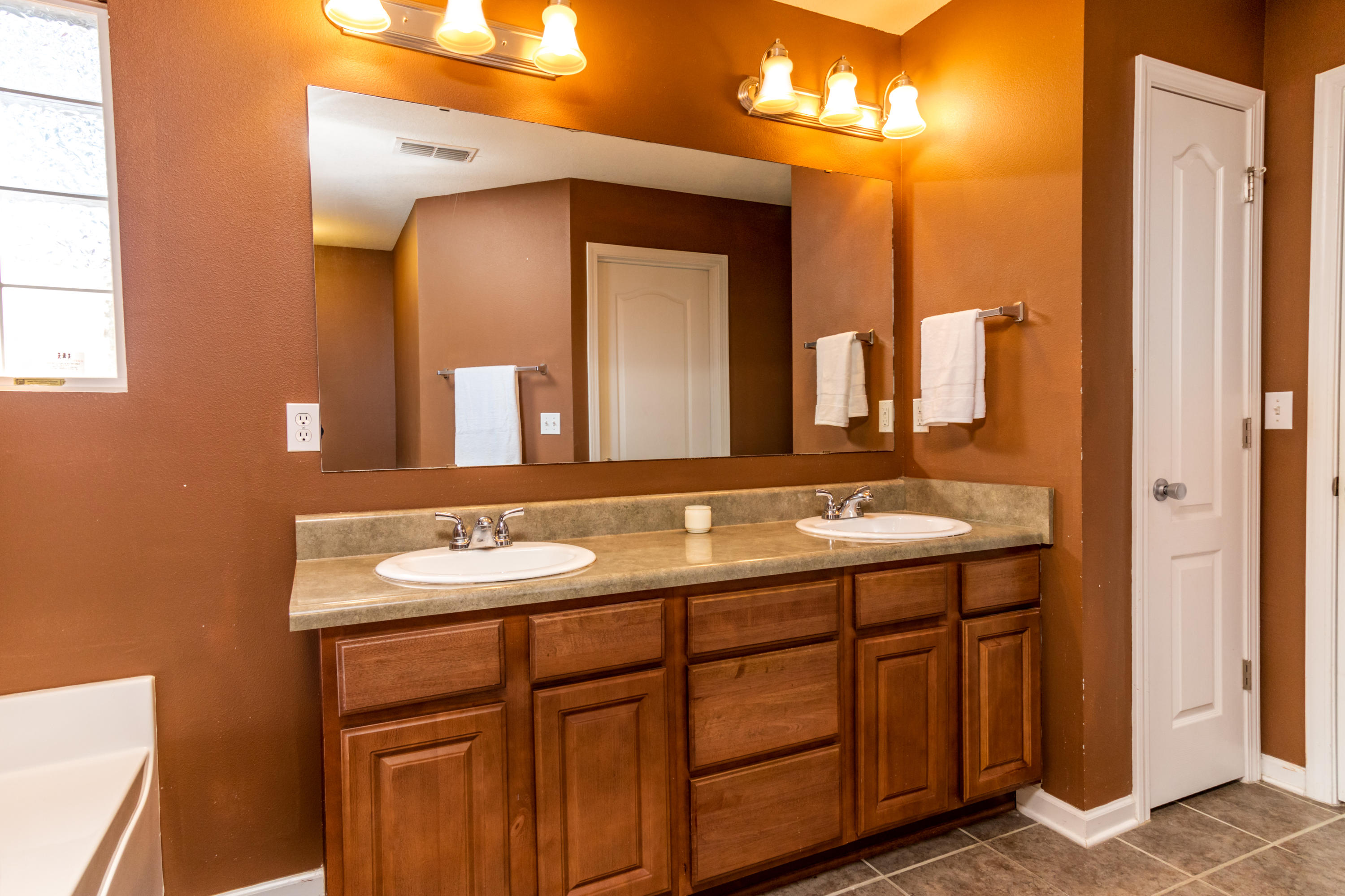 2609 Corner Creek Road Crestview, FL 32536 - Photo 17 of 22 a bathroom with a double vanity sink and a mirror