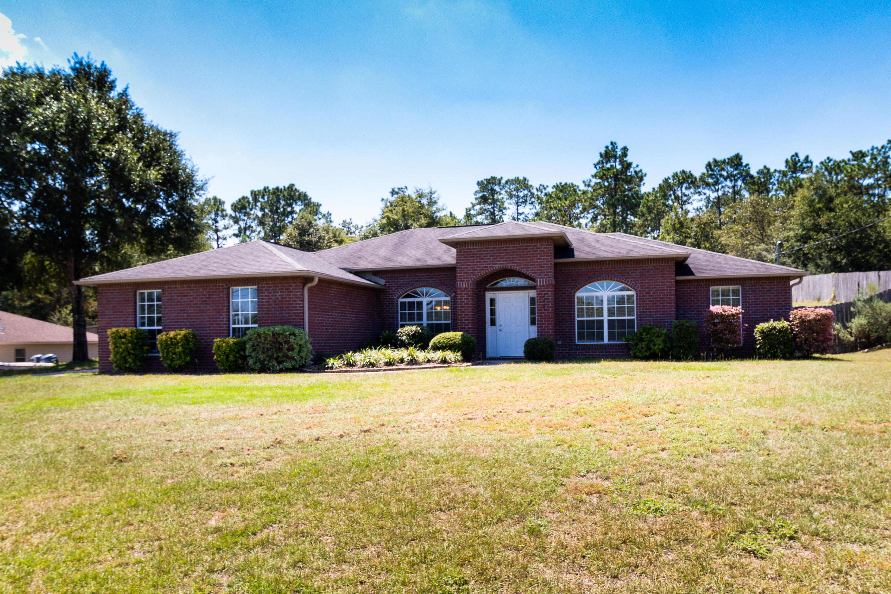 2609 Corner Creek Road Crestview, FL 32536 - Photo 2 of 22 a front view of a house with yard and trees