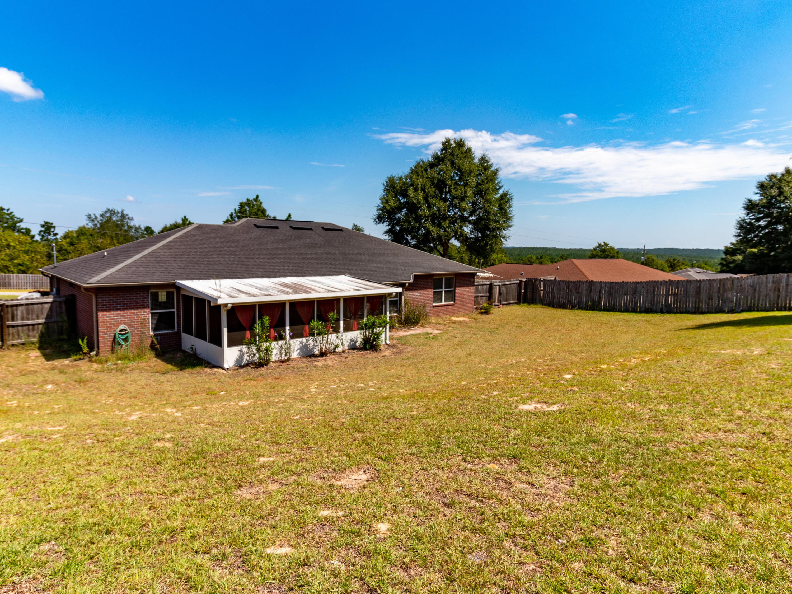 2609 Corner Creek Road Crestview, FL 32536 - Photo 22 of 22 a view of a swimming pool with lawn chairs under an umbrella