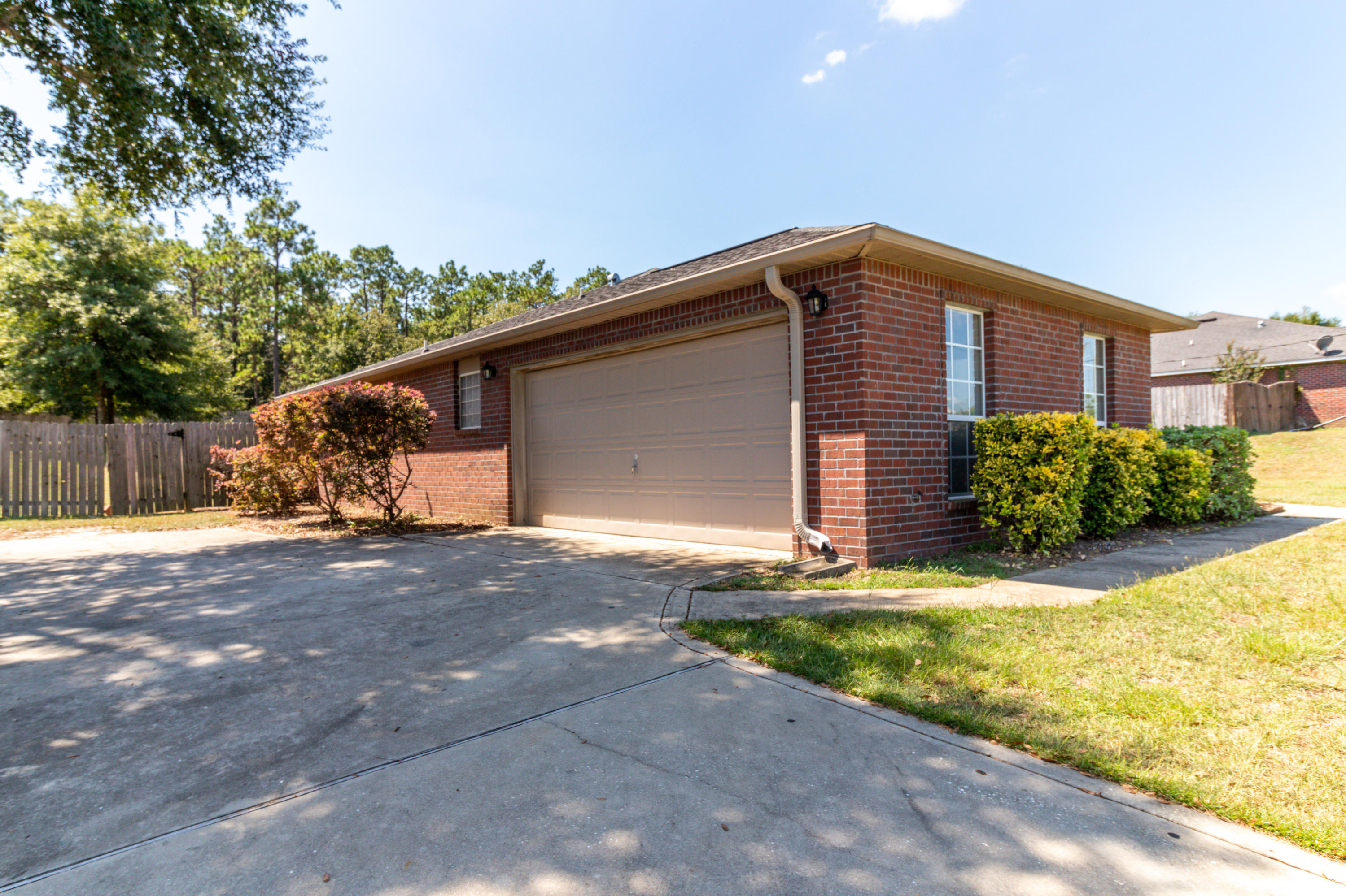 2609 Corner Creek Road Crestview, FL 32536 - Photo 3 of 22 a front view of a house with a yard and garage