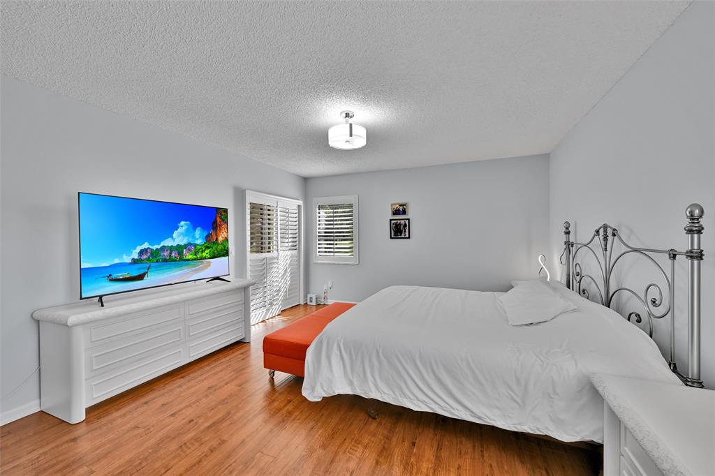 10788 Waterberry Drive Boca Raton, FL 33498 - Photo 14 of 30 a bedroom with a bed and a flat screen tv