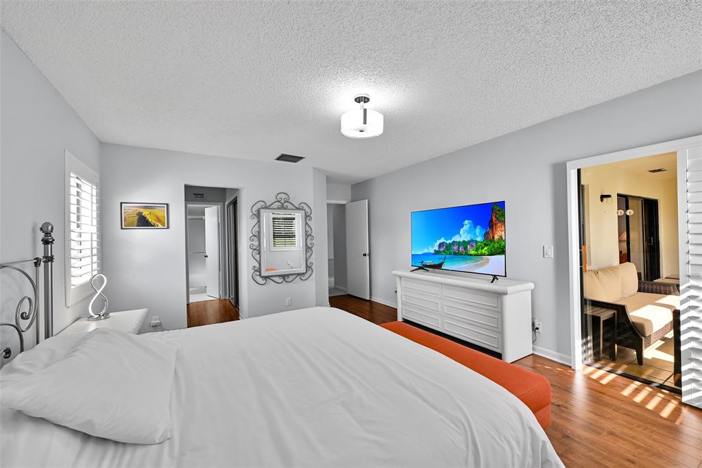 10788 Waterberry Drive Boca Raton, FL 33498 - Photo 15 of 30 a bedroom with a bed and a flat screen tv