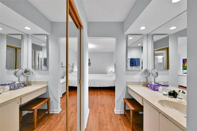 a en suite bathroom with a granite countertop sink and a mirror