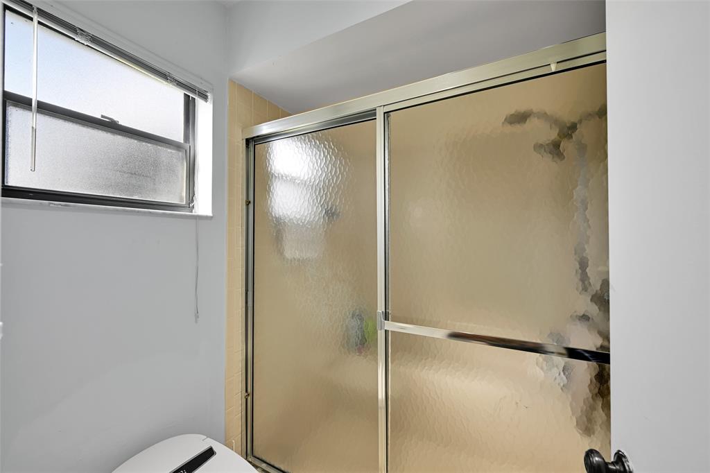 10788 Waterberry Drive Boca Raton, FL 33498 - Photo 17 of 30 a bathroom that has a glass shower door