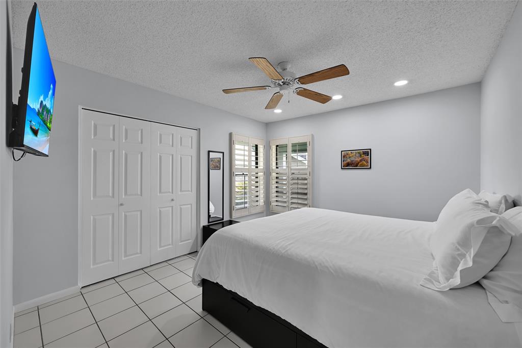 10788 Waterberry Drive Boca Raton, FL 33498 - Photo 18 of 30 a bedroom with a bed and a window