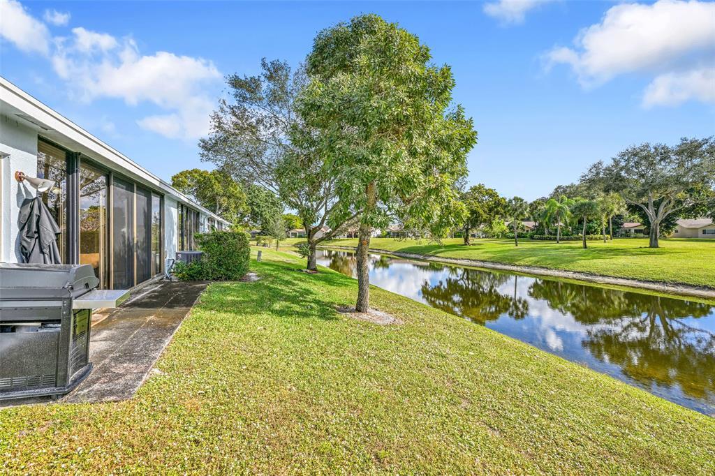 10788 Waterberry Drive Boca Raton, FL 33498 - Photo 2 of 30 a view of a lake with a garden