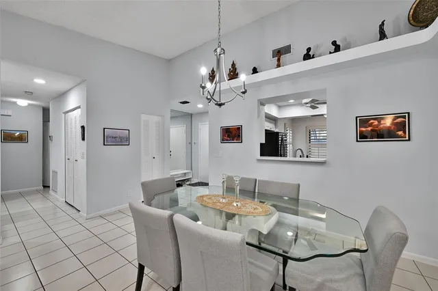 a view of a livingroom and a dining room with furniture wooden floor and chandelier