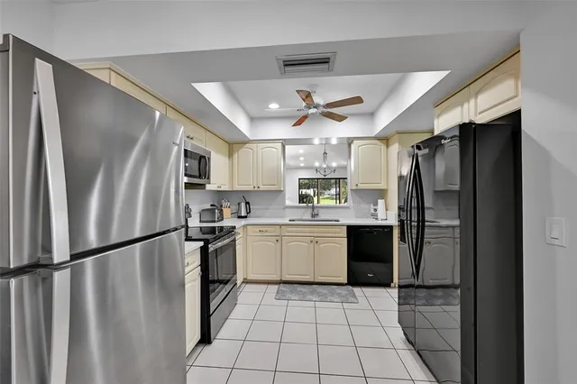 a kitchen with stainless steel appliances a refrigerator sink and microwave