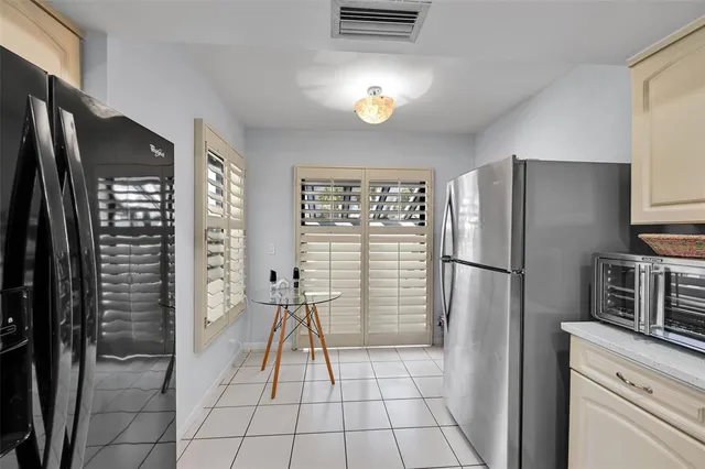 a kitchen with a refrigerator a stove and a sink