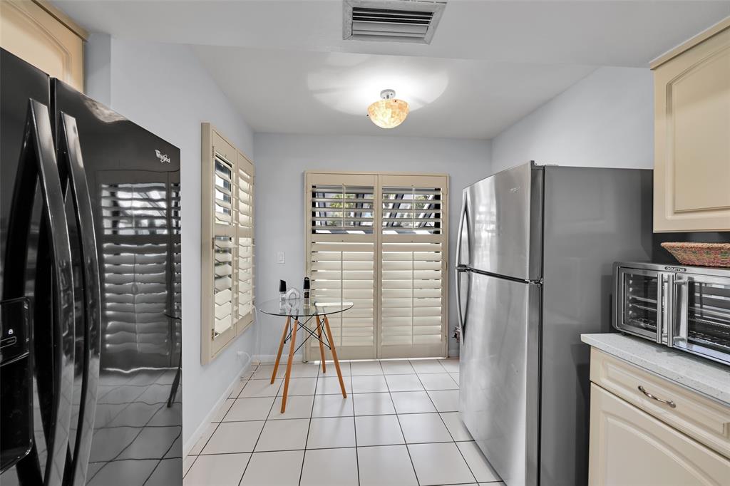 10788 Waterberry Drive Boca Raton, FL 33498 - Photo 10 of 30 a kitchen with a refrigerator a stove and a sink