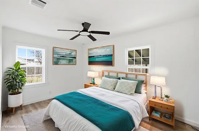 a bedroom with a bed and wooden floor