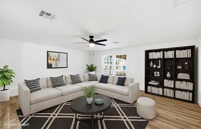 a living room with furniture a rug and a table