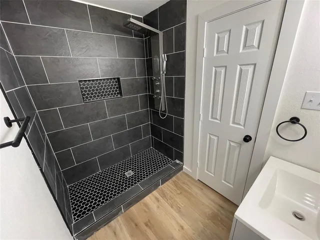 a bathroom with a sink toilet and shower