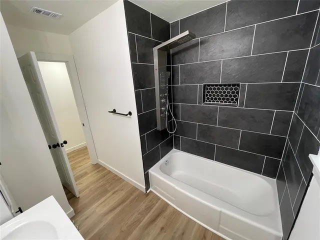 a bathroom with a bathtub and a toilet