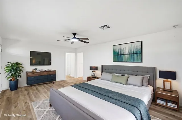 a bedroom with a bed and a flat screen tv