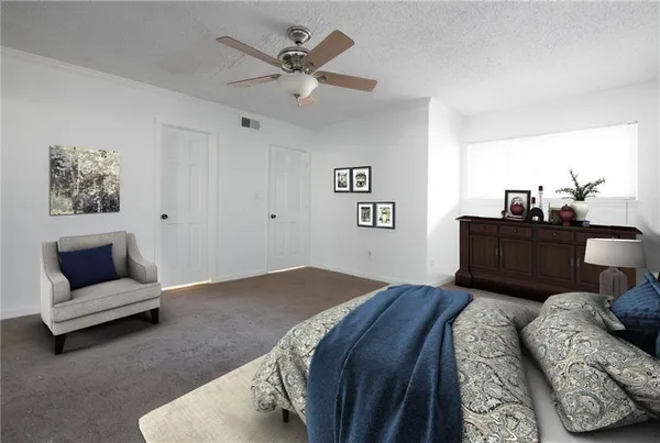 a bedroom with a large bed and furniture