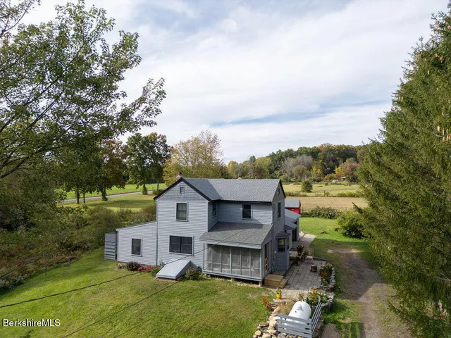 an aerial view of a house with a big yard