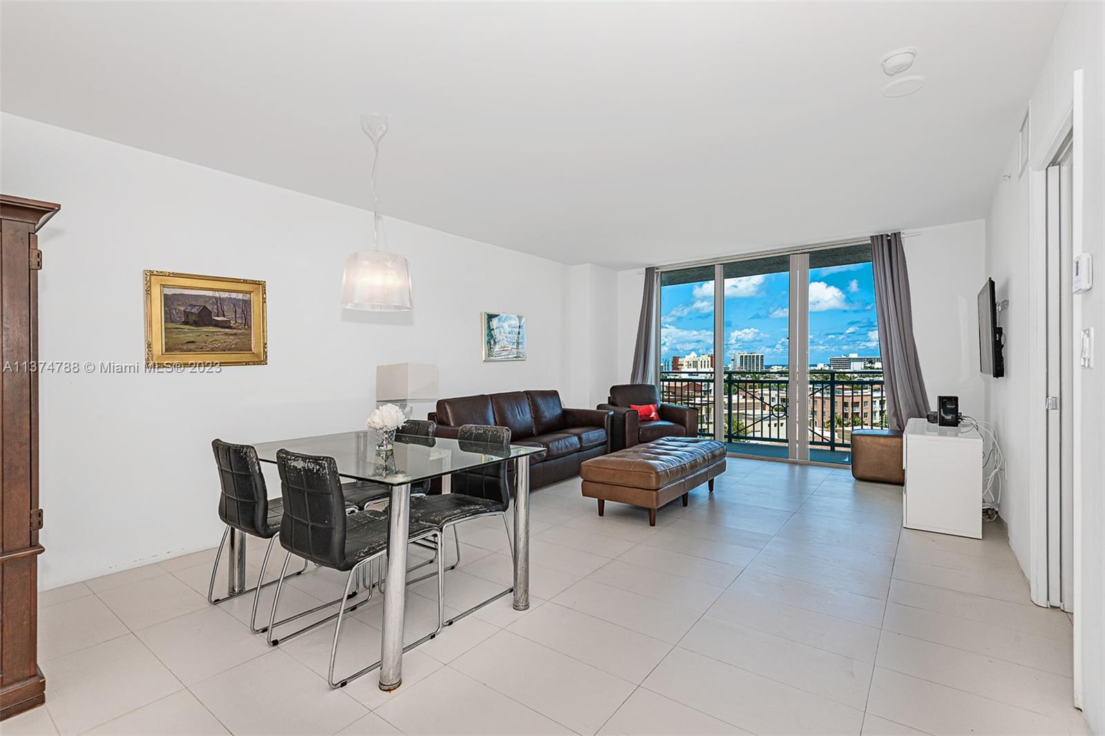 90 Alton Road, Unit 905 Miami Beach, FL 33139 - Photo 1 of 33 a living room with furniture and a large window