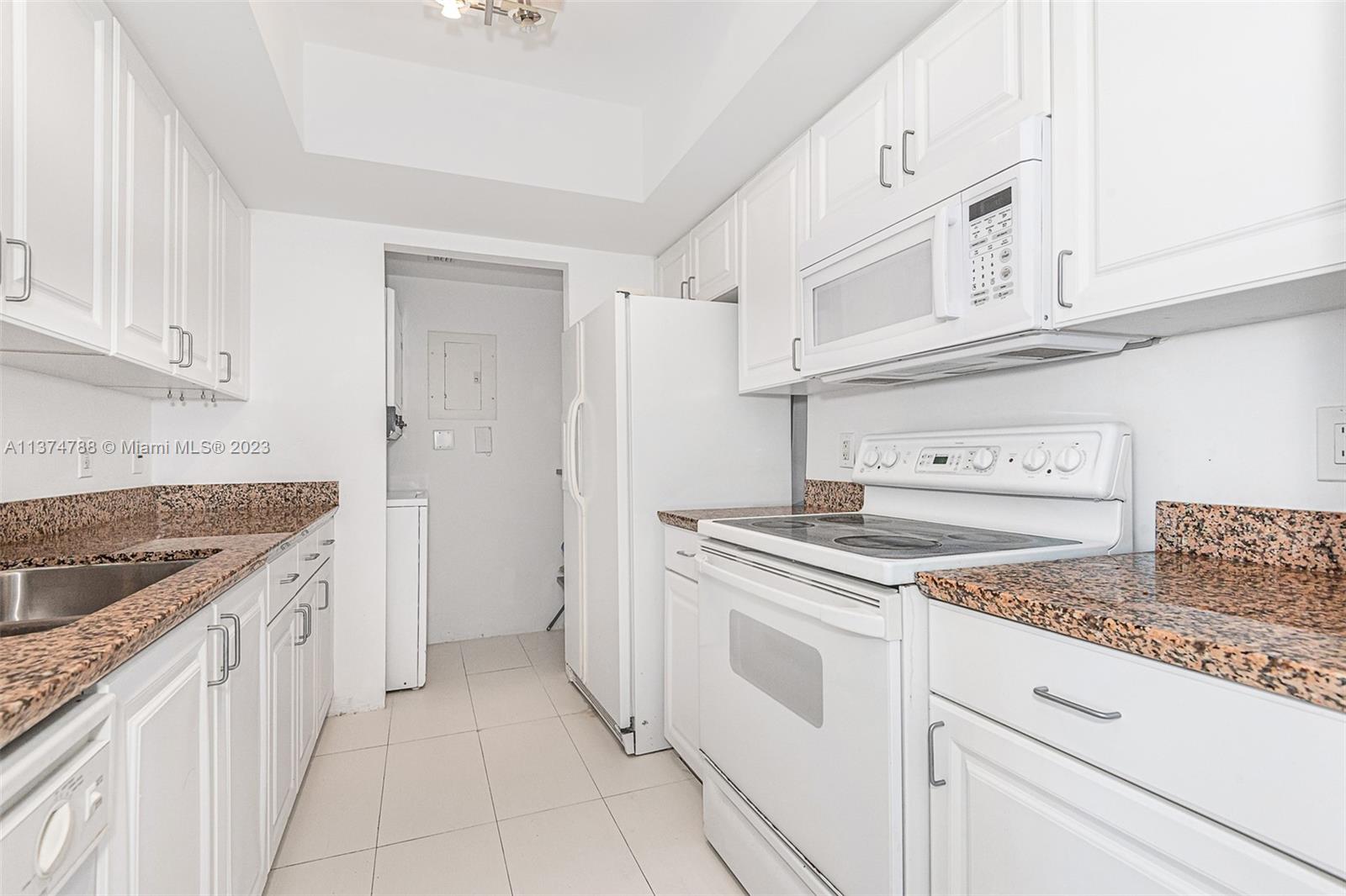 90 Alton Road, Unit 905 Miami Beach, FL 33139 - Photo 12 of 33 a kitchen with stainless steel appliances granite countertop a sink and a stove