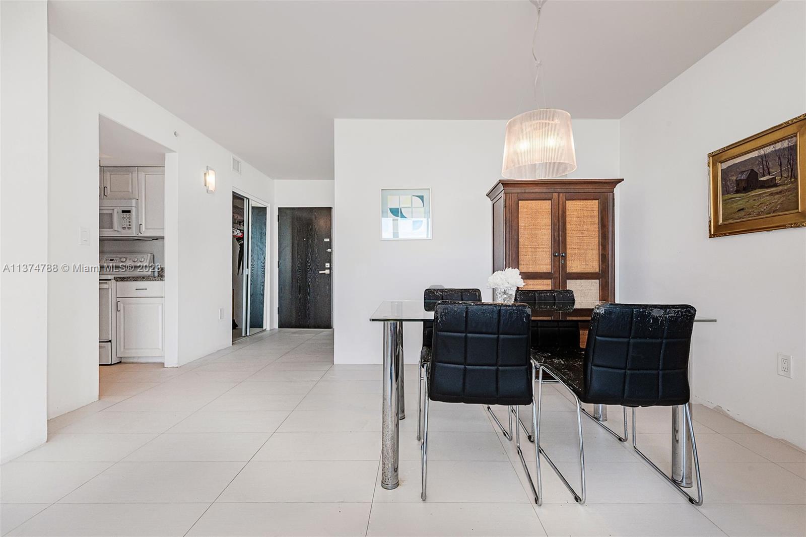 90 Alton Road, Unit 905 Miami Beach, FL 33139 - Photo 16 of 33 a view of a dining room with furniture