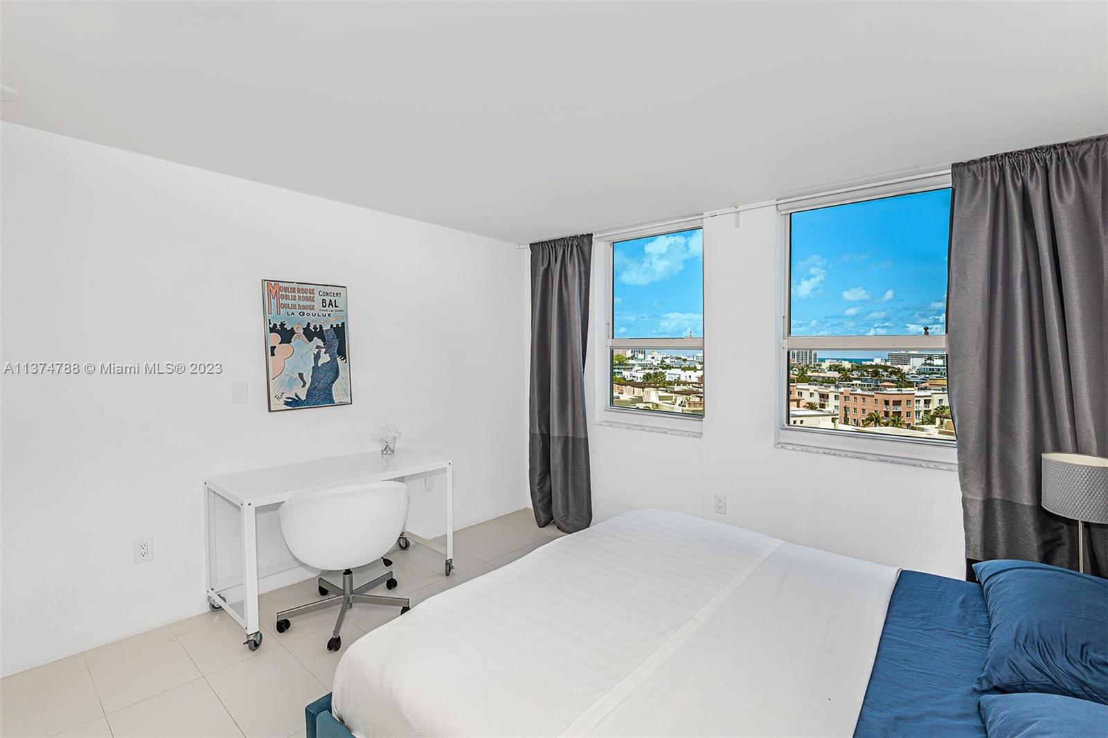 90 Alton Road, Unit 905 Miami Beach, FL 33139 - Photo 19 of 33 a bedroom with a bed and a chair with the wooden floor