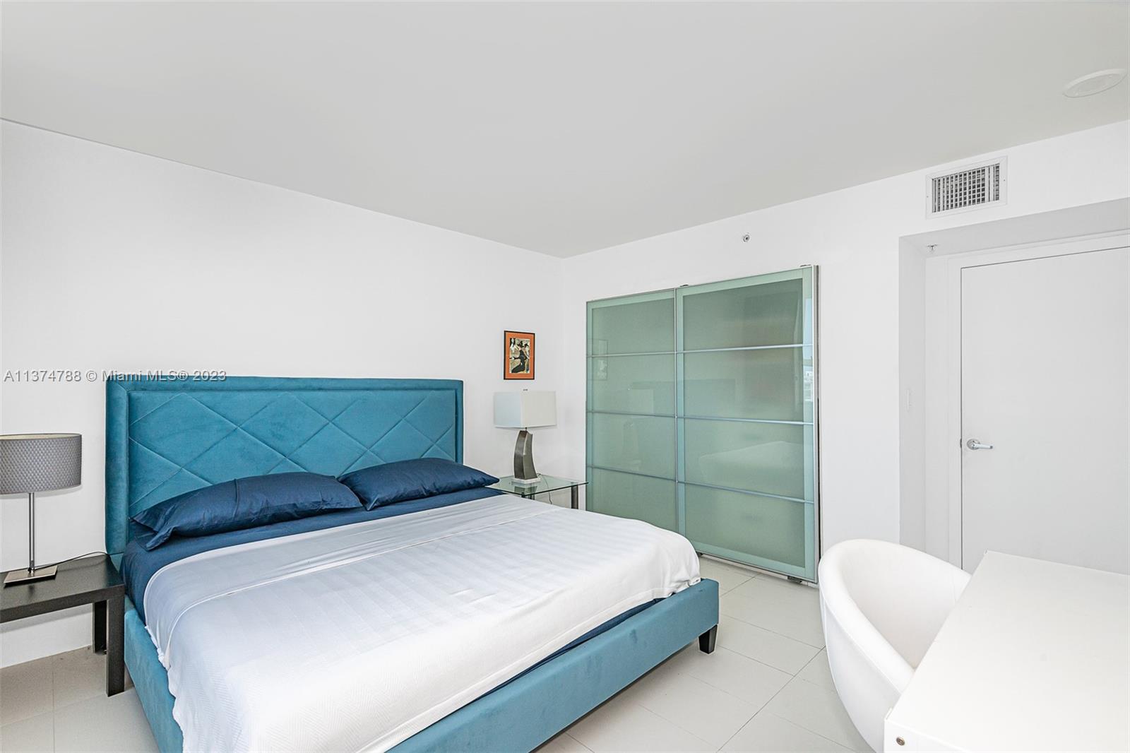 90 Alton Road, Unit 905 Miami Beach, FL 33139 - Photo 21 of 33 a bedroom with a bed and a couch