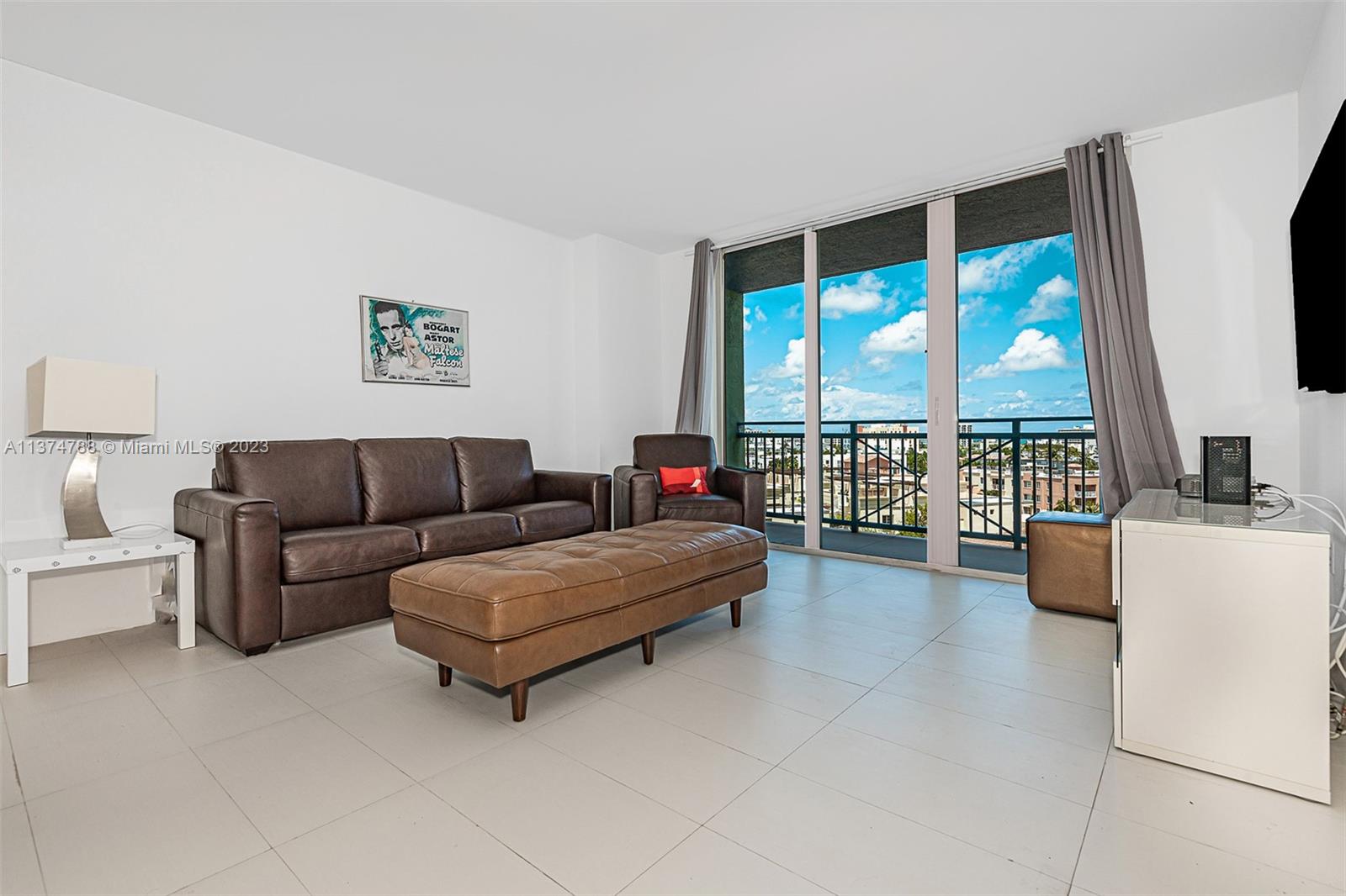 90 Alton Road, Unit 905 Miami Beach, FL 33139 - Photo 3 of 33 a living room with furniture and a flat screen tv