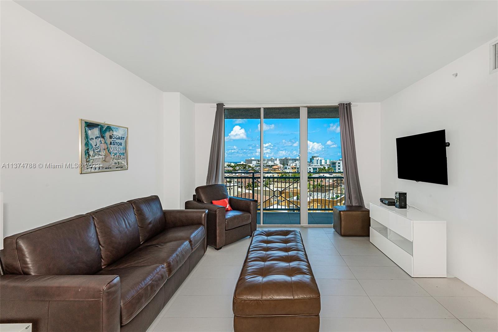 90 Alton Road, Unit 905 Miami Beach, FL 33139 - Photo 4 of 33 a living room with furniture and a flat screen tv