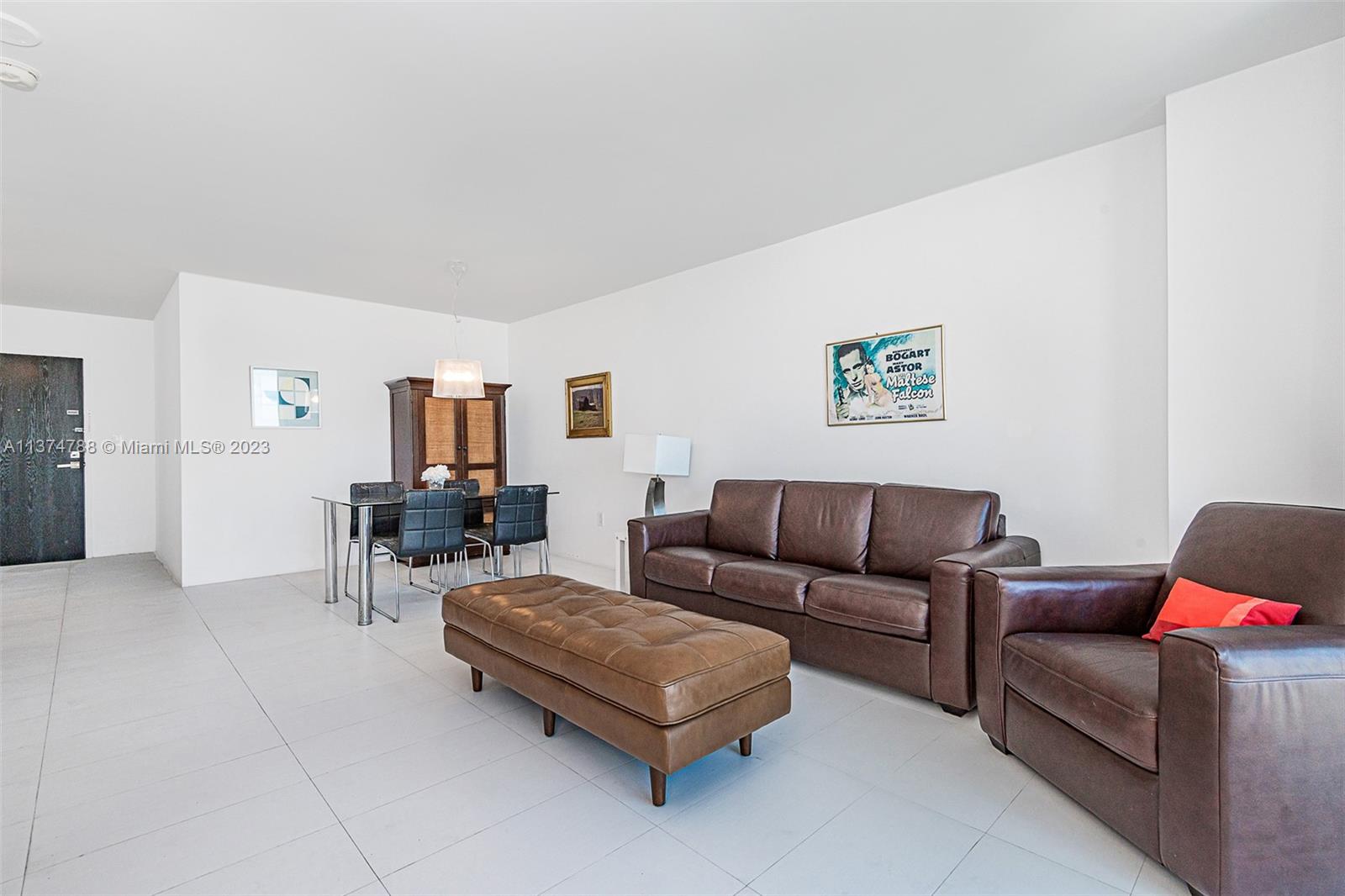 90 Alton Road, Unit 905 Miami Beach, FL 33139 - Photo 8 of 33 a living room with furniture and a table