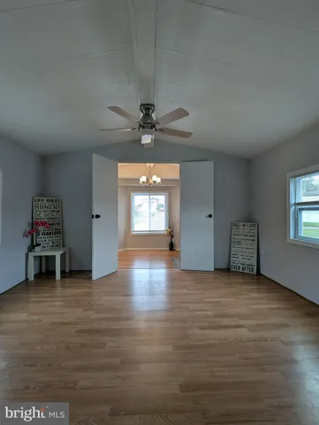 an empty room with windows and cabinet