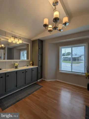 a bathroom with a double vanity sink and a large mirror
