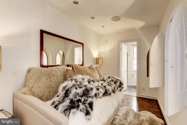 a bedroom with a bed and a mirror