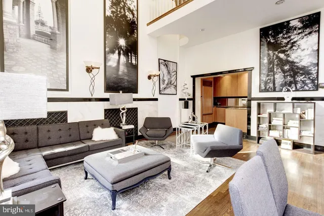 a living room with fireplace furniture and a floor to ceiling window