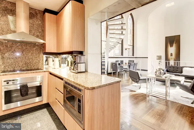 a kitchen with stainless steel appliances granite countertop a stove and a sink