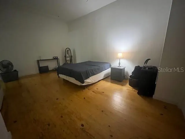 a bedroom with a bed and a dresser next to a window