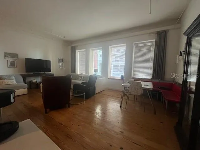 a living room with furniture a window and a flat screen tv
