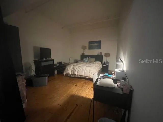 a bedroom with a bed and a tv on table