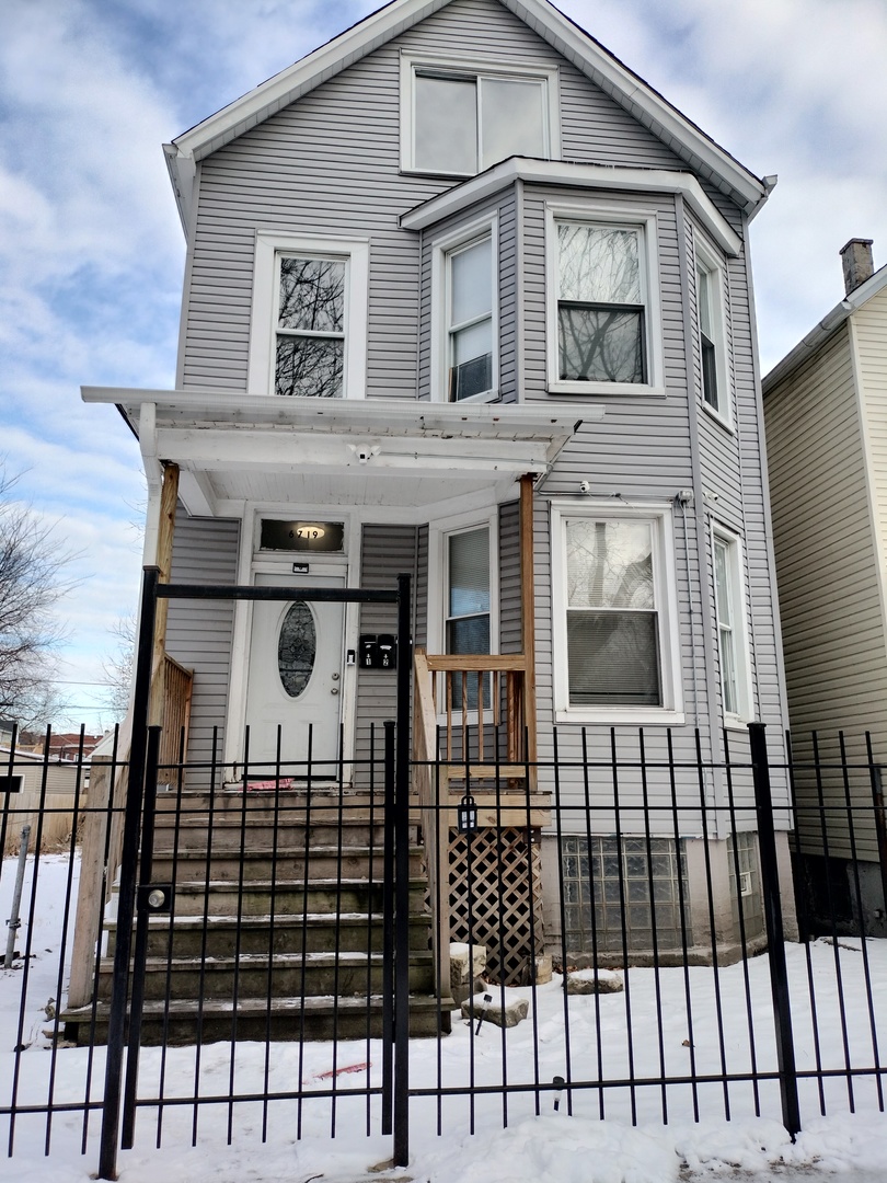 6719 South Sangamon Street, Unit 1 Chicago, IL 60621 - Photo 1 of 23 a view of a brick house with large windows