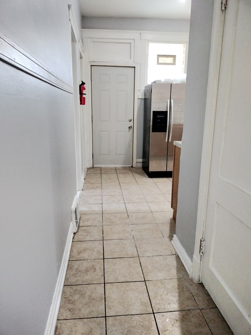 6719 South Sangamon Street, Unit 1 Chicago, IL 60621 - Photo 13 of 23 a view of a hallway to rooms