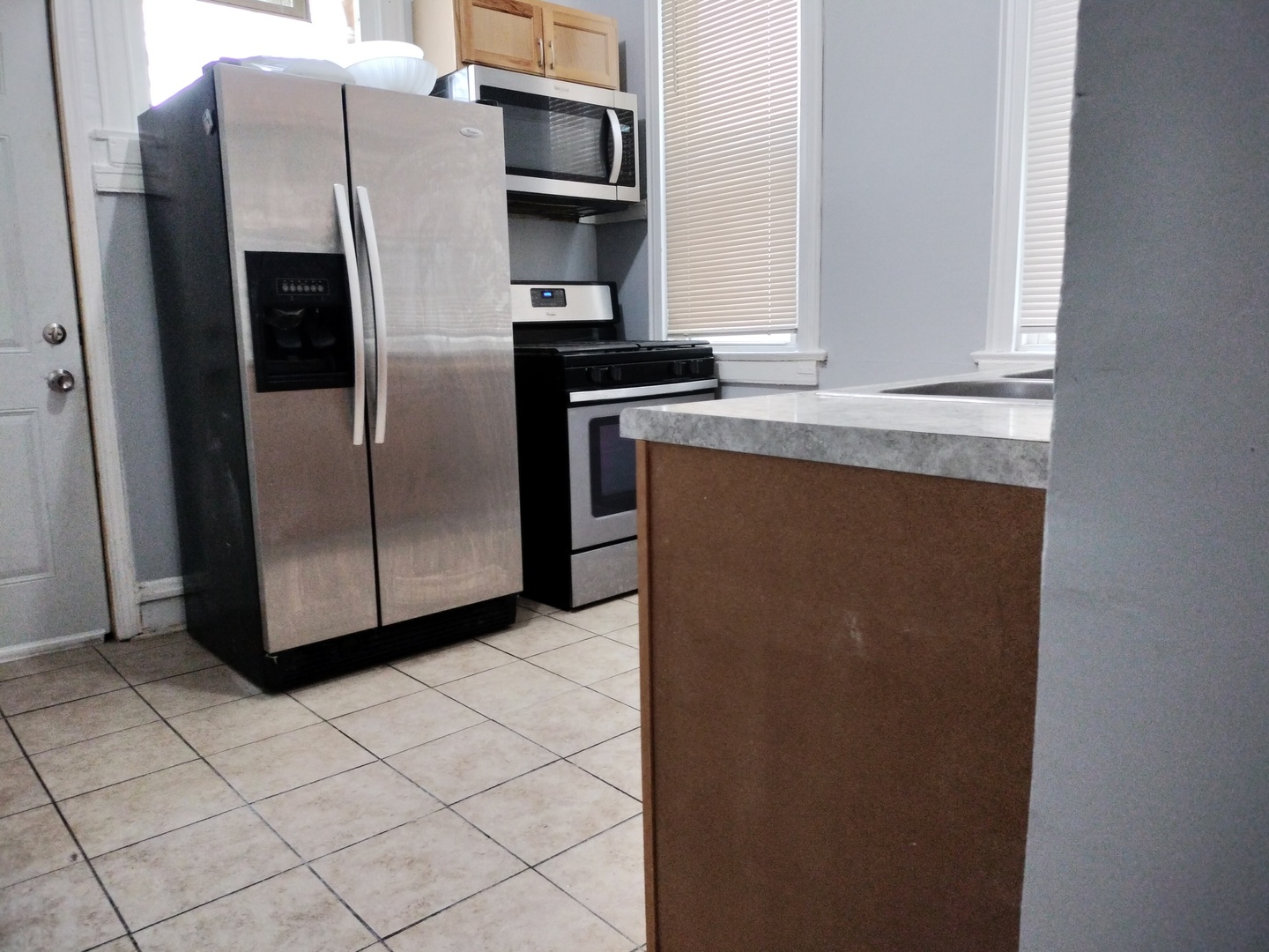 6719 South Sangamon Street, Unit 1 Chicago, IL 60621 - Photo 15 of 23 a kitchen with metallic refrigerator freezer and a dishwasher
