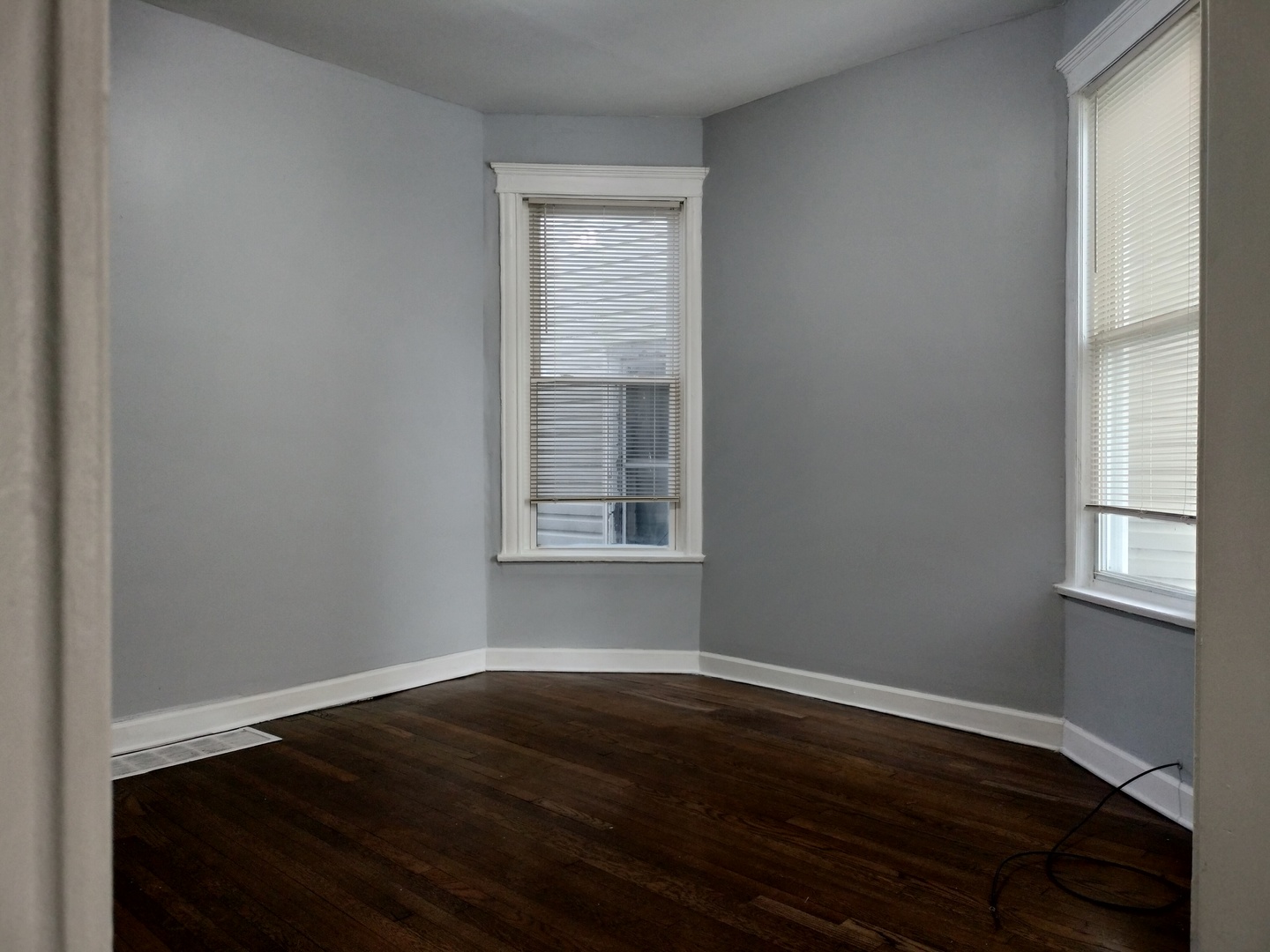 6719 South Sangamon Street, Unit 1 Chicago, IL 60621 - Photo 2 of 23 a view of an empty room with wooden floor and a window
