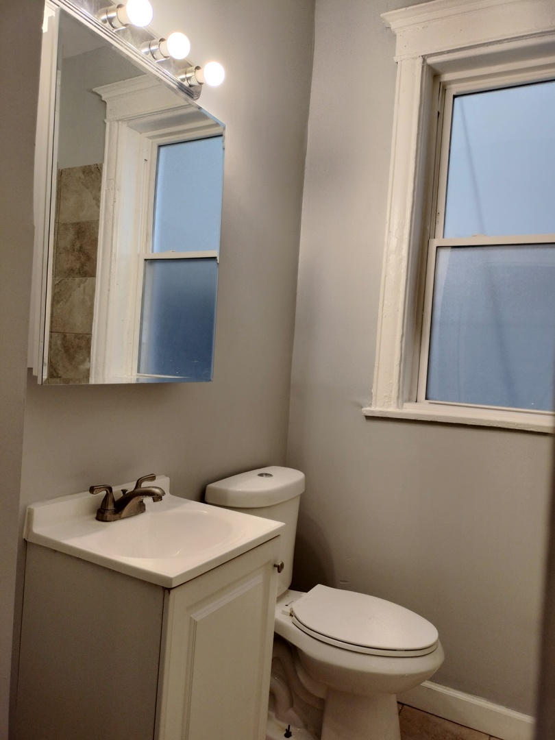 6719 South Sangamon Street, Unit 1 Chicago, IL 60621 - Photo 21 of 23 a bathroom with a sink and a toilet
