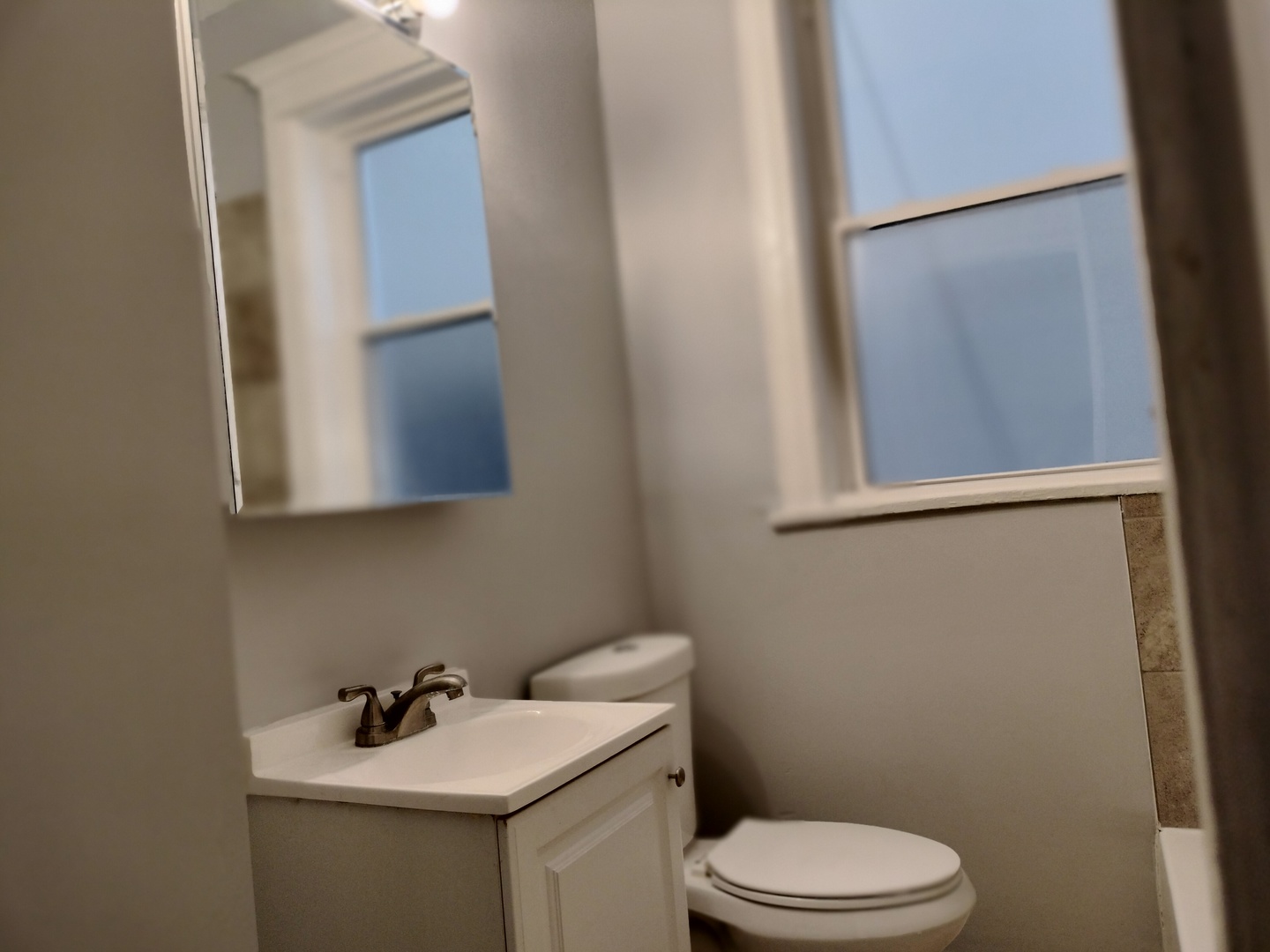 6719 South Sangamon Street, Unit 1 Chicago, IL 60621 - Photo 22 of 23 a bathroom with a sink a toilet and mirror