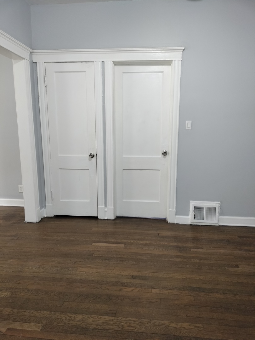 6719 South Sangamon Street, Unit 1 Chicago, IL 60621 - Photo 3 of 23 a view of wooden floor and closet in a room