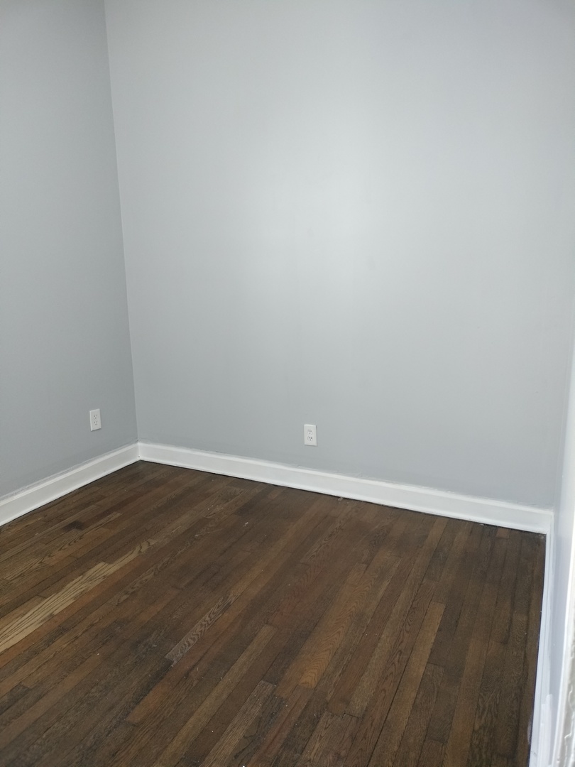 6719 South Sangamon Street, Unit 1 Chicago, IL 60621 - Photo 10 of 23 a view of an empty room with wooden floor