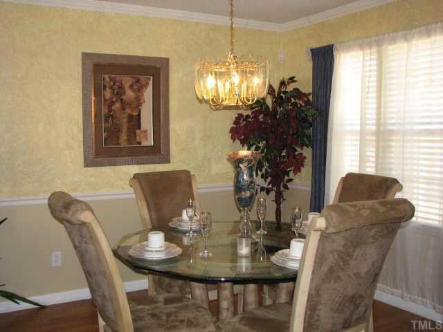 5604 Orchard Gate Way Raleigh, NC 27616 - Photo 4 of 8 Formal dining room features chair rail,crown molding, and beautiful flooring Other