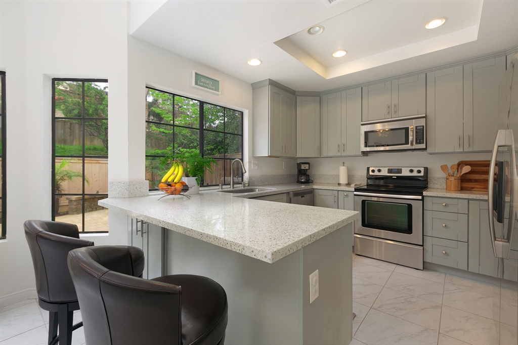 a kitchen with a stove a sink and a refrigerator